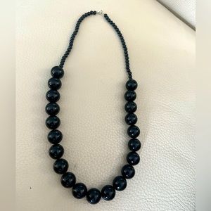 Necklace of dark brown circular beads